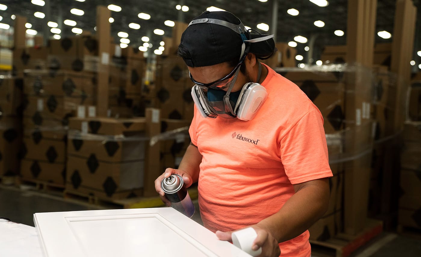 A Fabuwood team member finishing a cabinet door inside the Newark, NJ manufacturing facility.
